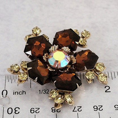 Vintage topaz rhinestone brooch next to a ruler.