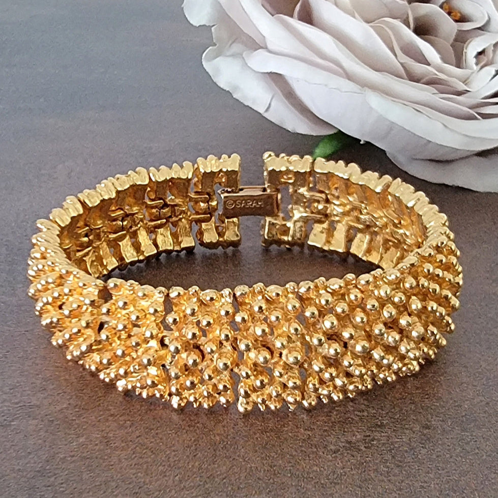 Gold tone knobby textured bracelet.