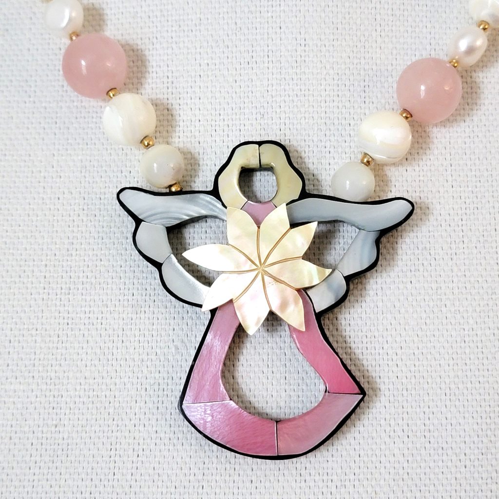 Pink shell inlay angel pendant.