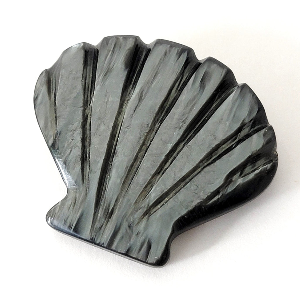 Vintage carved gray plastic shell pin.