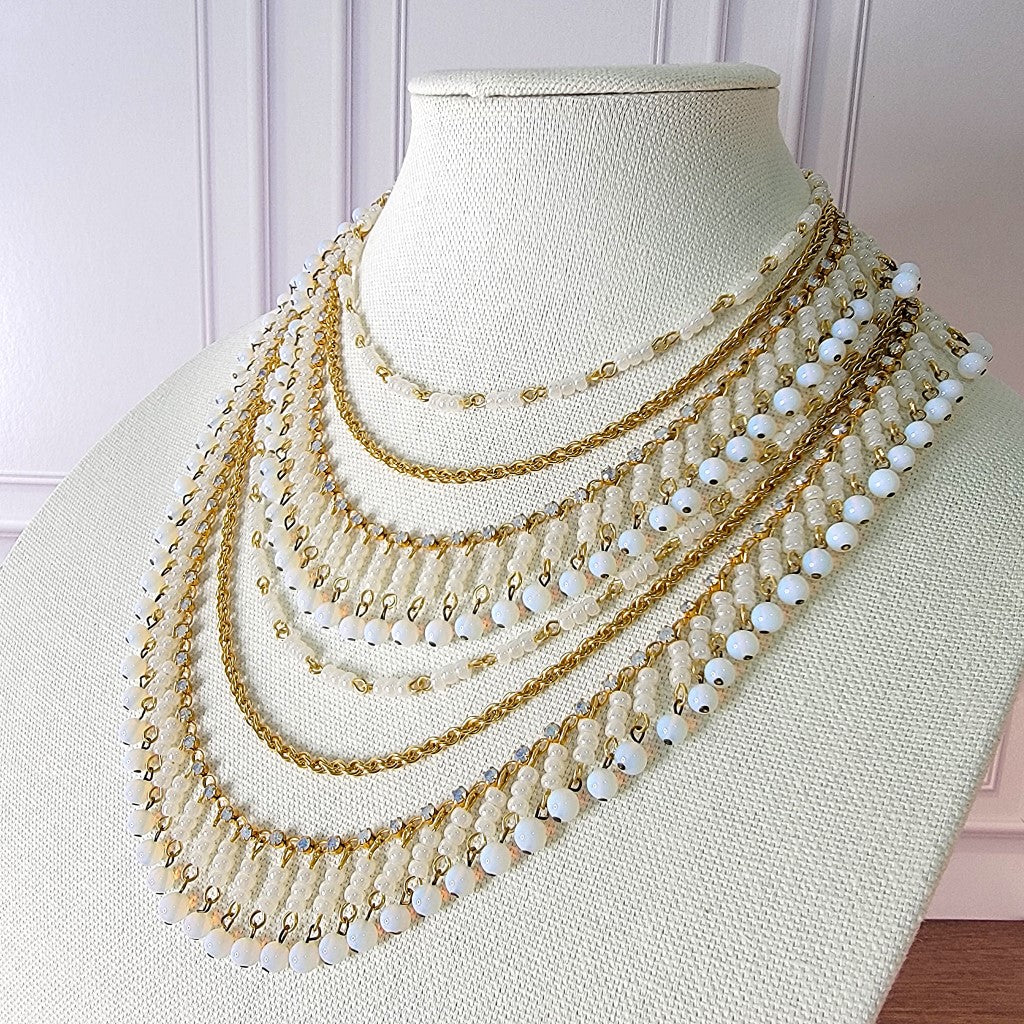 White glass bib style necklace.