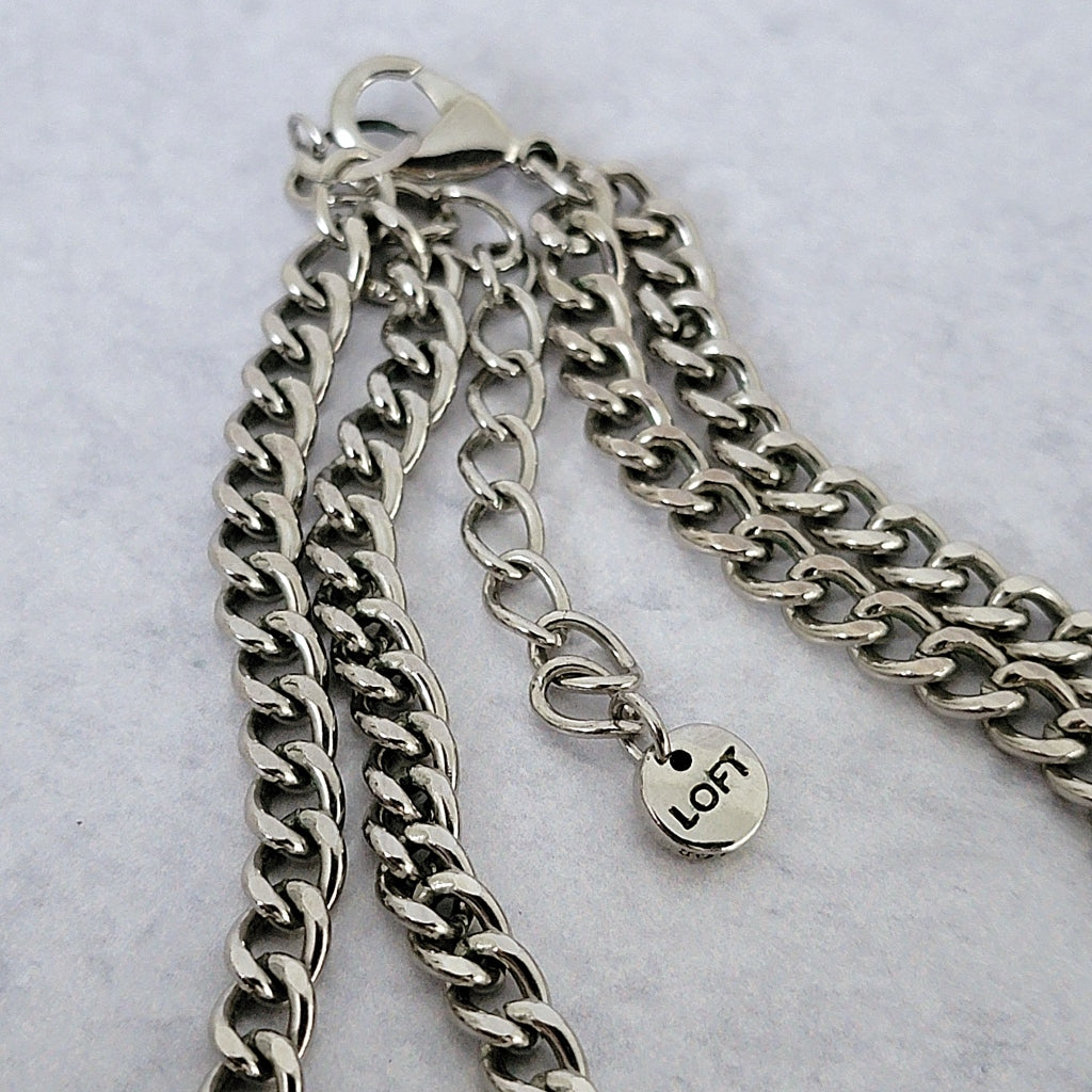 Silver tone chains and Loft signature tag.