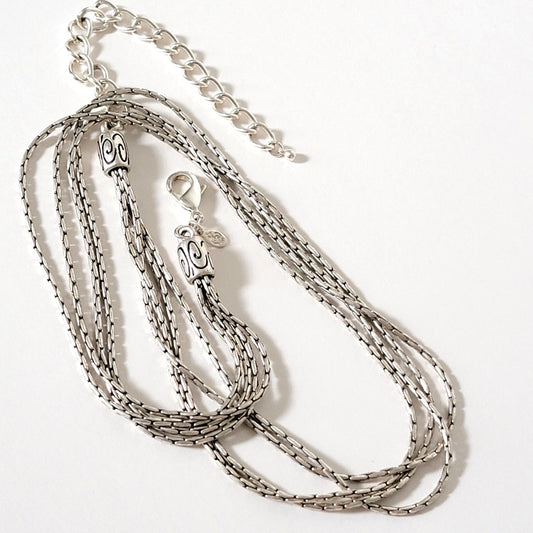 Four strand silver tone chain.