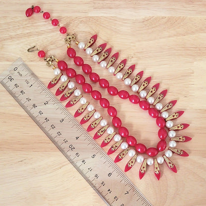 Red plastic spoke beaded necklace with ruler.