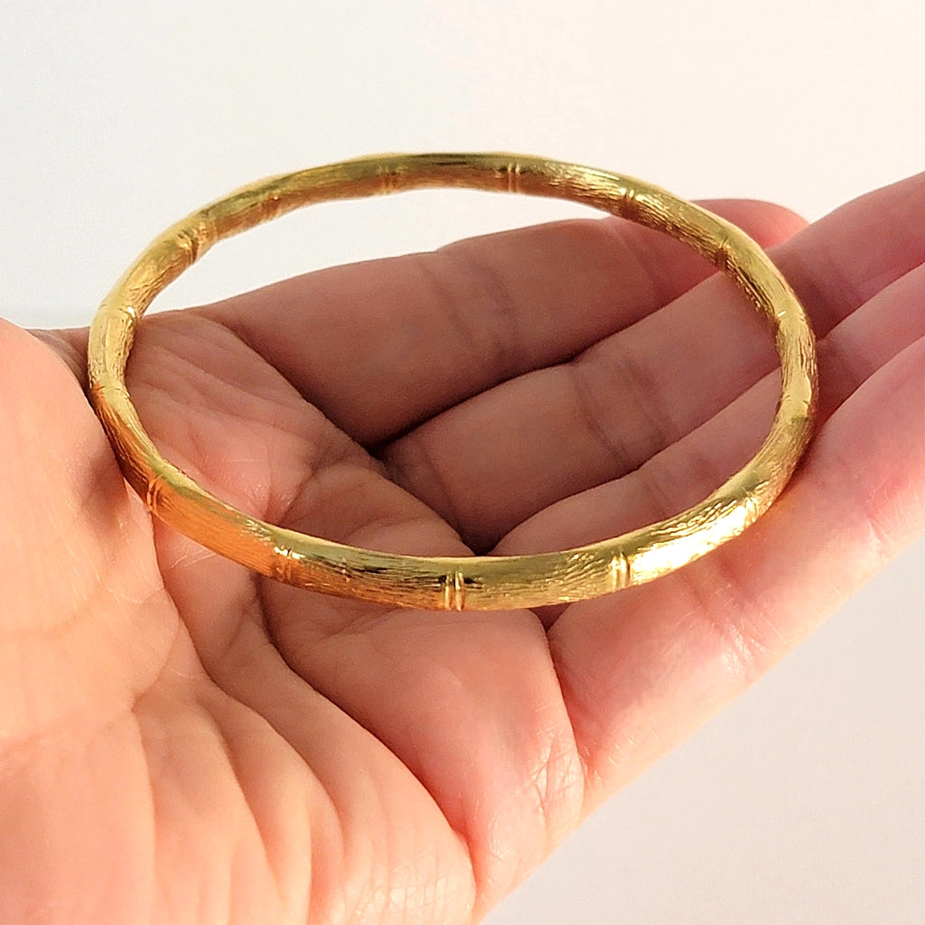 Vintage gold tone bracelet in hand.