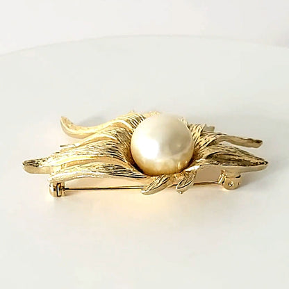 Top of faux pearl on a vintage brooch.