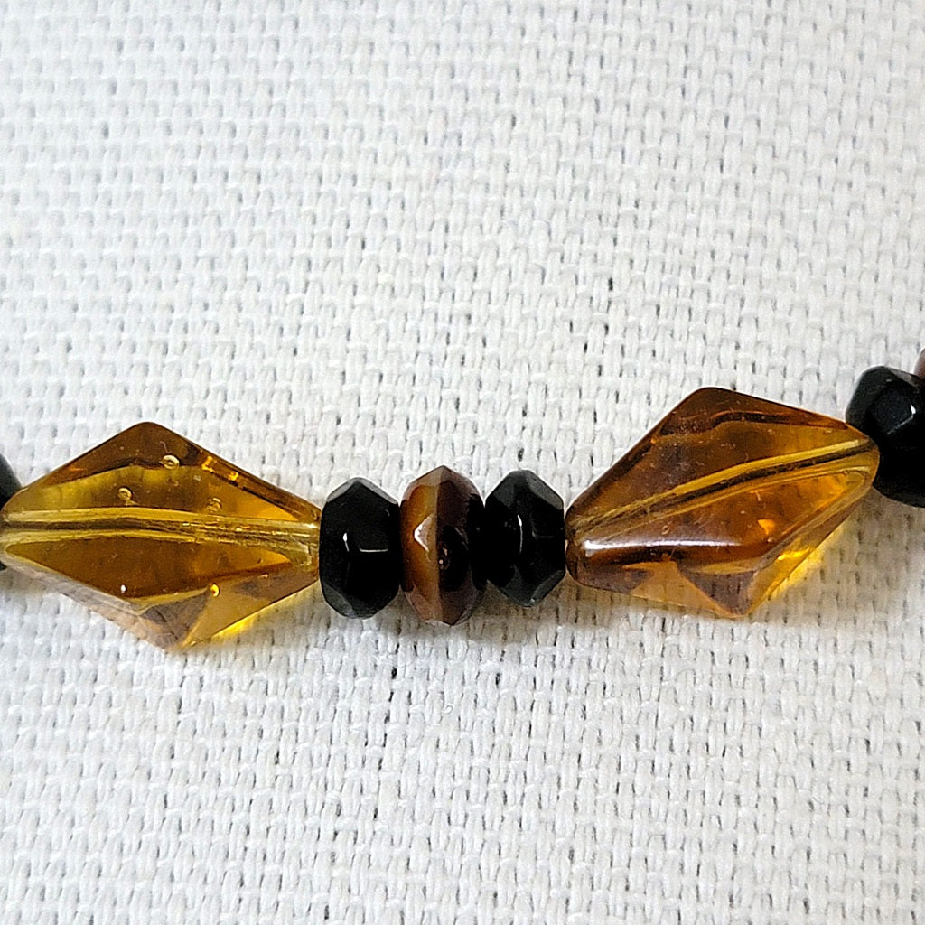 Amber brown and black glass beads.