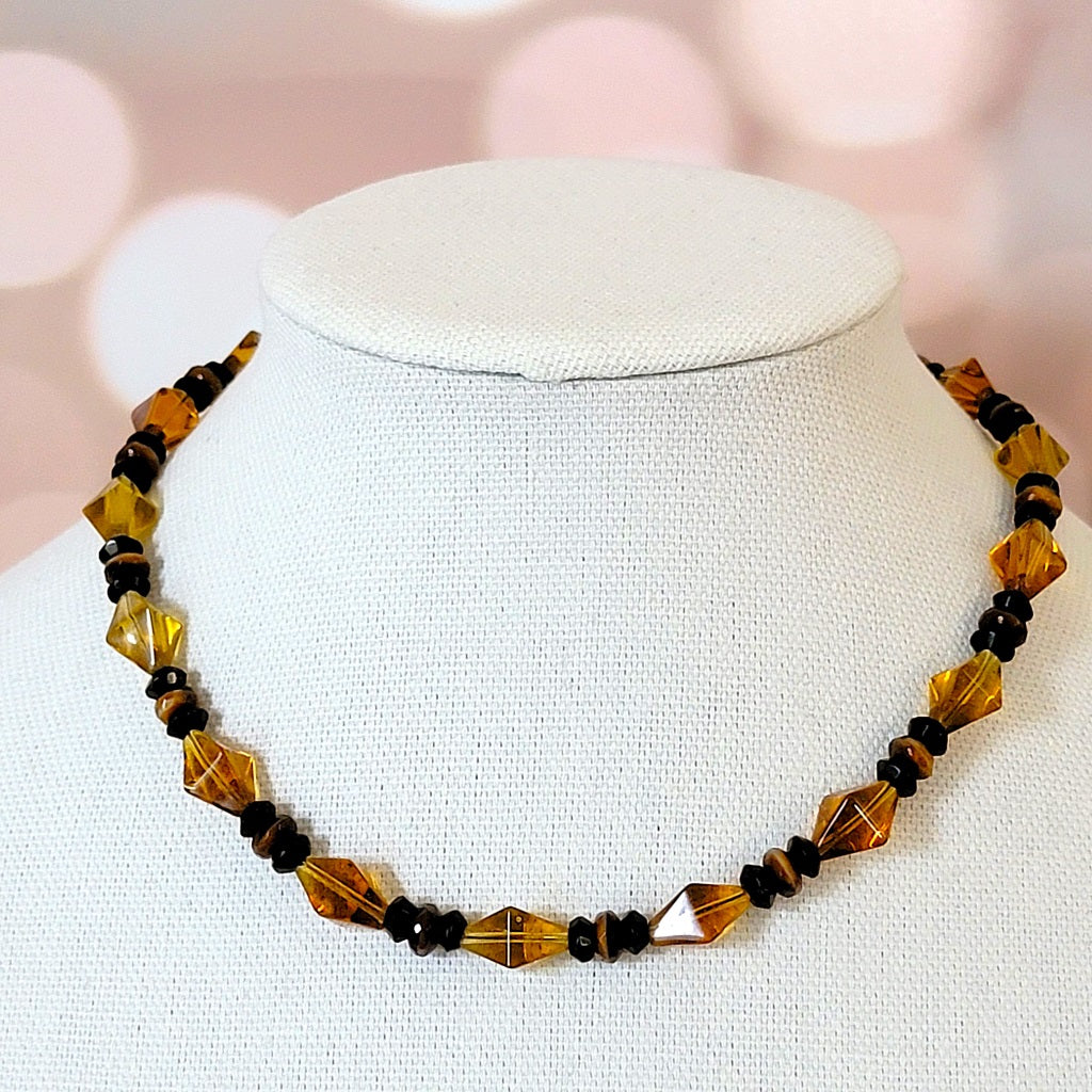 Topaz orange glass choker on stand.