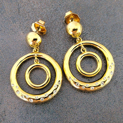 Gold tone double hoop dangle earrings.