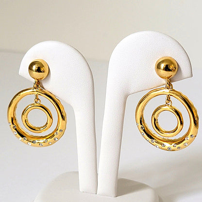 Double gold tone hoop earrings on stand.