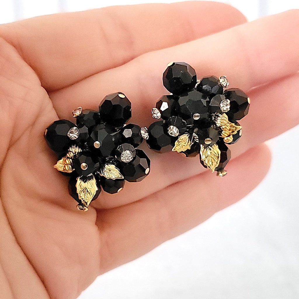 Black Vendome earrings in hand.