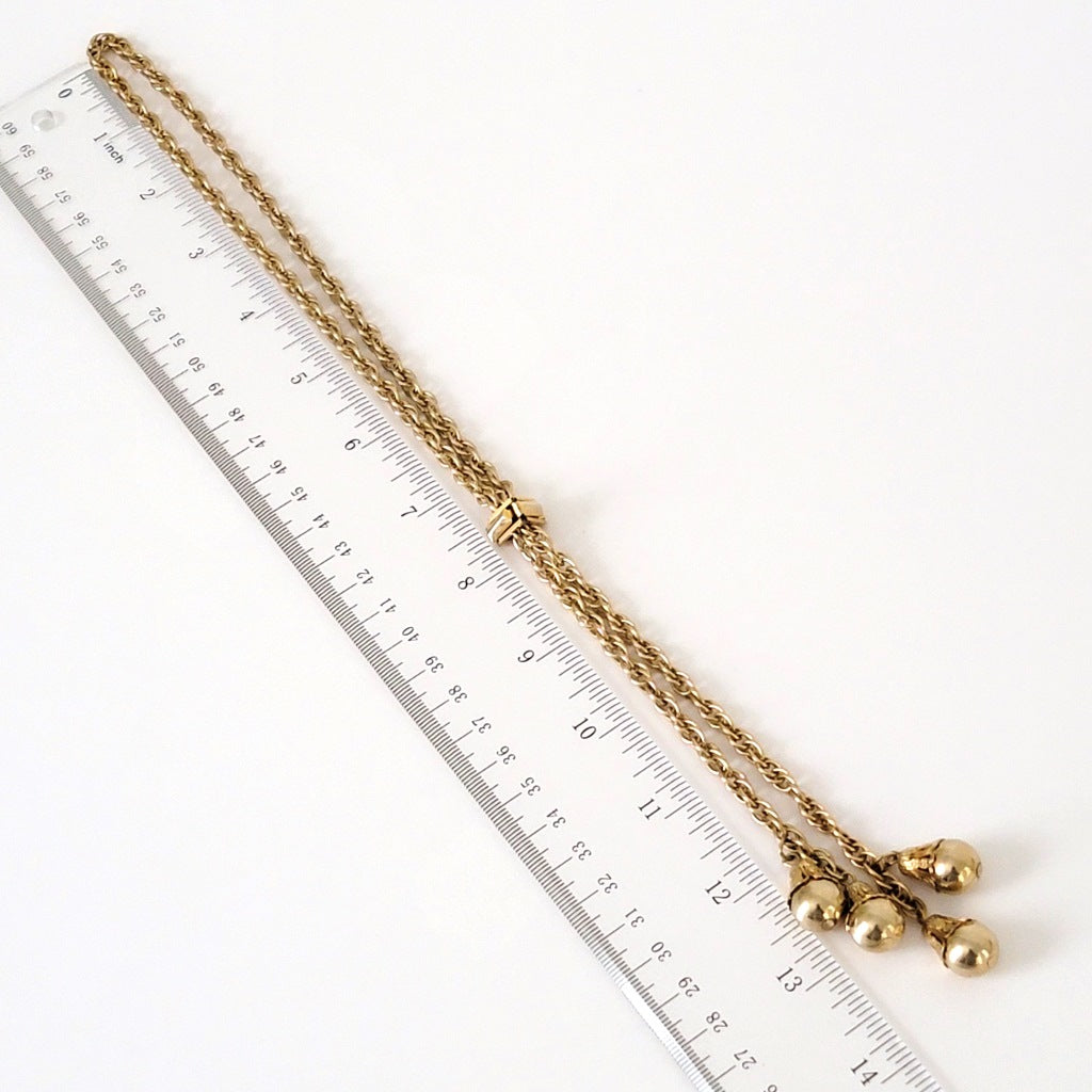 Gold tone bolero necklace with ruler.