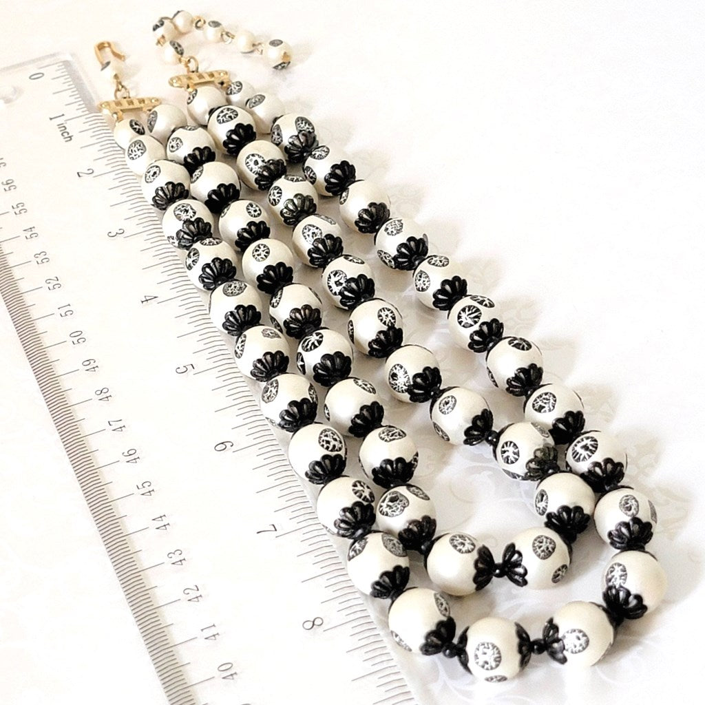 Beaded necklace with ruler.