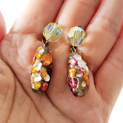 Vintage dangle earrings in hand.