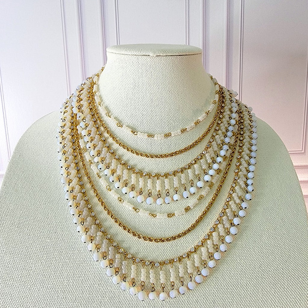 White dangle bead multistrand necklace.