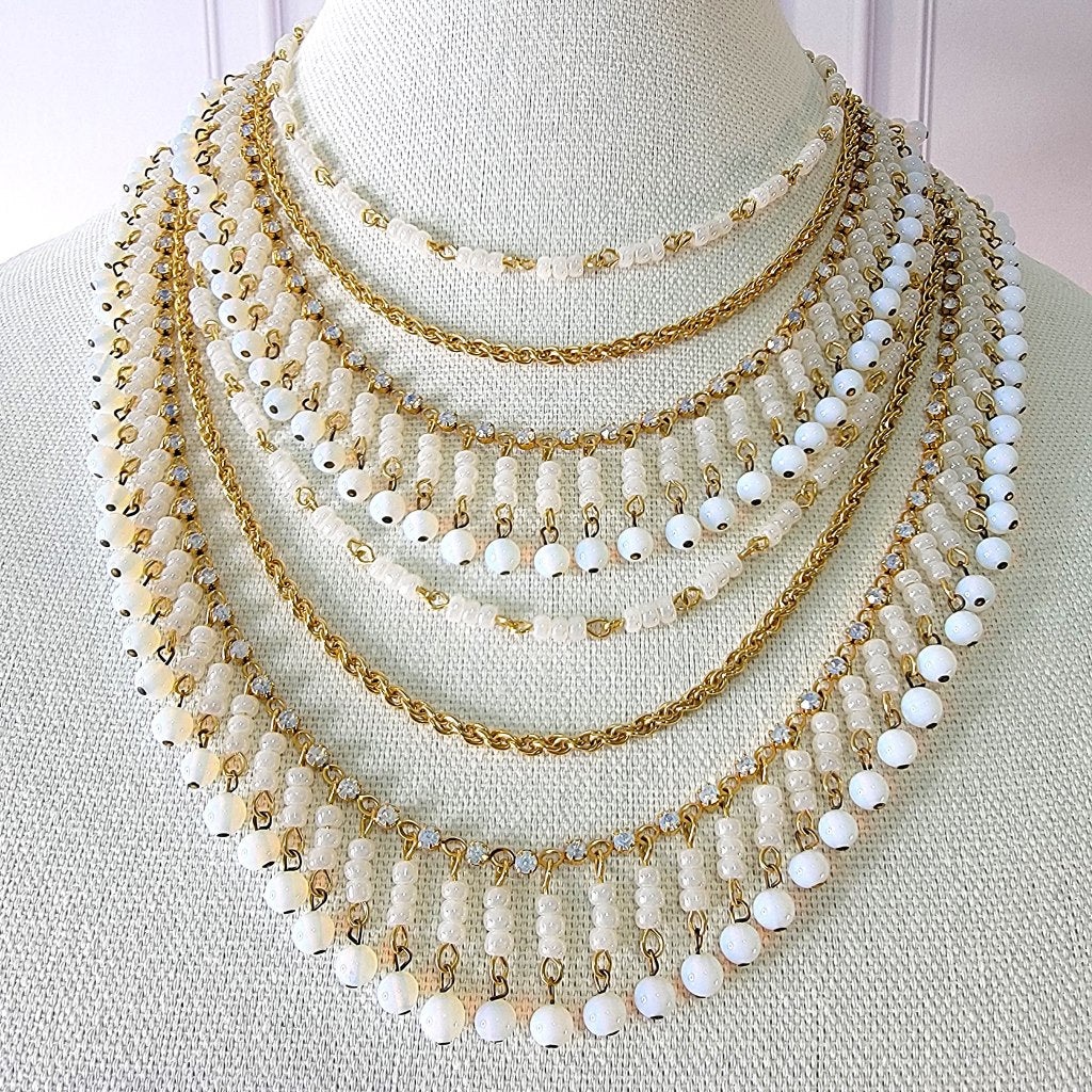 White multistrand bib necklace.