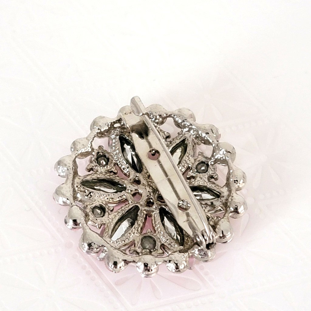 Back view of pink 80s rhinestone brooch.