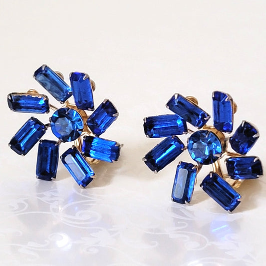 Vintage sapphire blue, baguette rhinestone clip on earrings, with a pinwheel style prong setting.